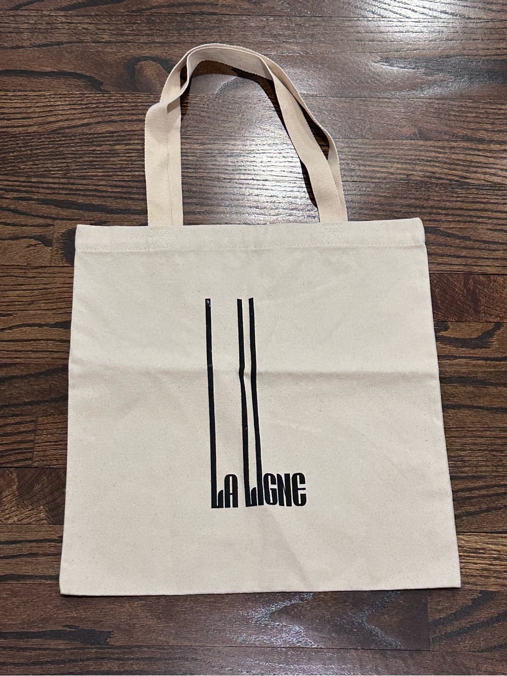 La Ligne Cream Canvas Tote with Black Vertical Logo Stripes